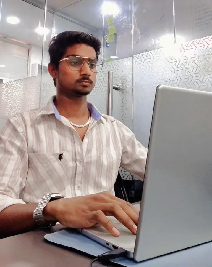 Hasnain working on a laptop